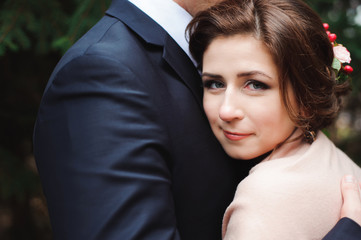 Bride and groom hugging in a forest in the autumn forest, weddin