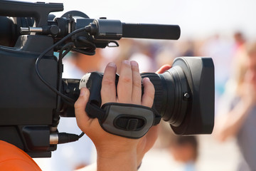 The operator photographer takes on a professional camera interviews in the mass celebration.