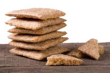 stack of crisp bread on a wooden table isolated  white background