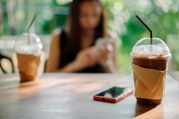 Young woman using smartphone in coffee shop.