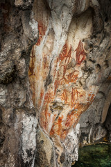 Preshistoric petroglyph rock paintings in Raja Ampat, West Papua, Indonesia. Aborigines from Australia left their markings in the form of rock paintings in and around Misool Island in Raja Ampat.
