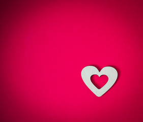wooden heart on a pink background