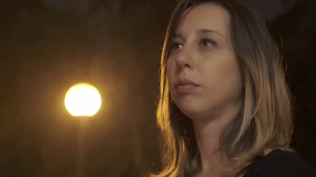 lonely young prostitute in the street on a rainy night