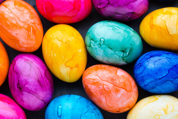 Easter eggs painted in colors on a pattern background.