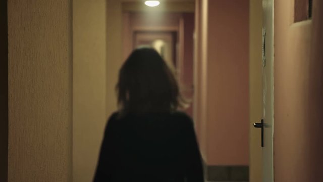 young woman walking on a hotel corridor and is attacked by a kidnapper