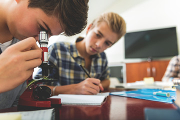 Focused male pupils at lesson