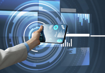 Media technology concept presented by businessman holding tablet with graphs and diagrams