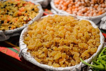 View of dried fruits and nuts in market. Various assortment colorful background