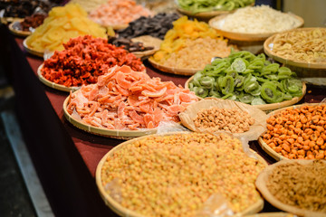 Colorful variety dry fruits and nuts in the street shop vibrant background