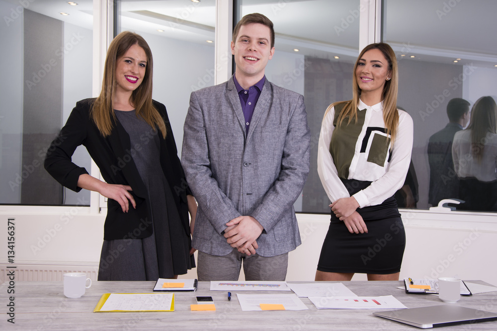 Wall mural Portrait of a business team. Young and successful men and women working together.