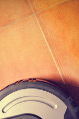 Smart design technology and robotic vacuum cleaner on floor background. Wireless cleaning device...