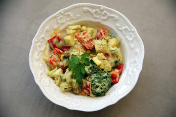 Homemade bell peppers and broccoli salad with spicy dressing on