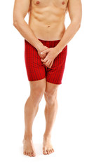 Medical concept. Closeup of man in red boxers with health problem on white background