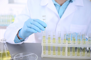 Fototapeta premium Doctor examining the urine in laboratory, closeup