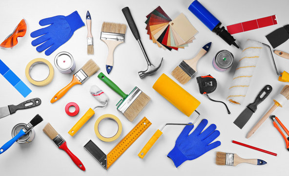 Set of professional decorator equipment on white background