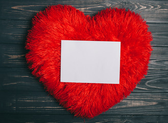 Decorations for Valentine's Day. heart pillow and letter on wooden background