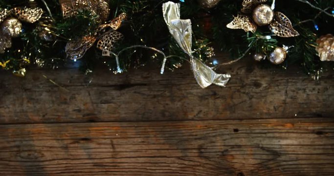 Wreath with christmas lights and decoration on a plank