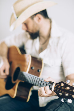 Cowboy touching the acoustic guitar