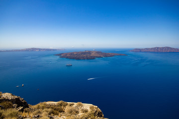 Fototapeta na wymiar Panorama of Nea Kameni, a small uninhabited Greek island of volcanic origin located in the Aegean Sea and Santorini caldera.