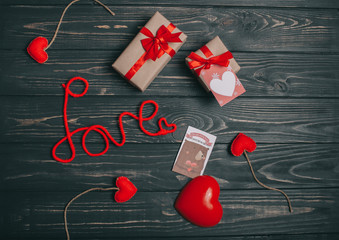 decorations for Valentine's Day. gifts, heart and the words "Love" on wooden background