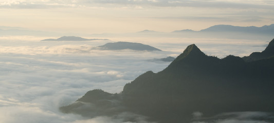 Fototapeta na wymiar A view from hill of North Thailand in morning february and sunlight emanate on clouds flow