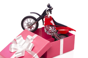 Motorcycle in gift box isolated on white background