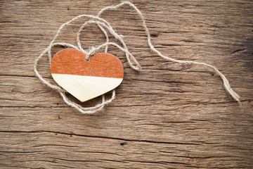 wooden heart with rope on old wooden