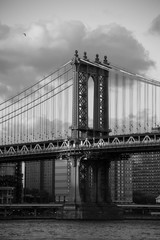 Fototapeta na wymiar Manhattan bridge with cloudy sky in black and white style, New York