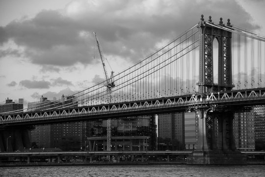 Manhattan bridge over the river and the city in black and white style, New York © Spinel