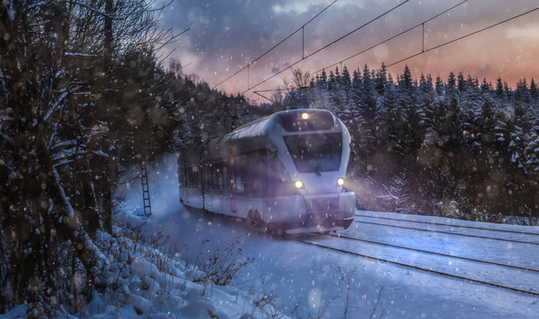 Fototapeta train speeding in a snowy winter night