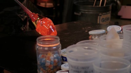Glassblower shaping a molten glass