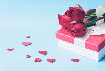Valentines Concept, Roses Bouquet on top of Red Present Box with