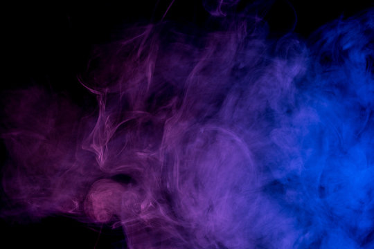 Abstract smoke Weipa. Personal vaporizers fragrant steam. The concept of alternative non-nicotine smoking. Blue lilac smoke on a black background. E-cigarette. Evaporator. Taking Close-up. Vaping.