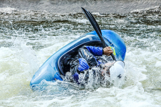 Kayak on whitewater. Focus on back of kayak and water