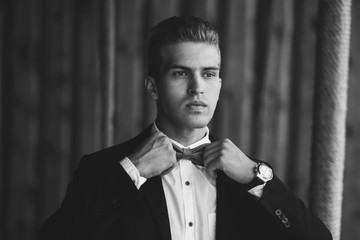 Stylish handsome groom wearing bow-tie. Luxury fashion wedding