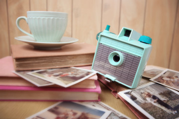 Still life with vintage camera and photos. Blur effect, focus on