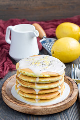 Homemade lemon and chia seed pancakes with citrus glaze, vertical, copy space
