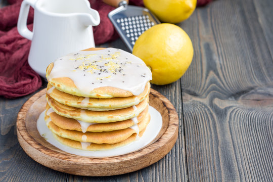 Homemade lemon and chia seed pancakes with citrus glaze, horizontal, copy space