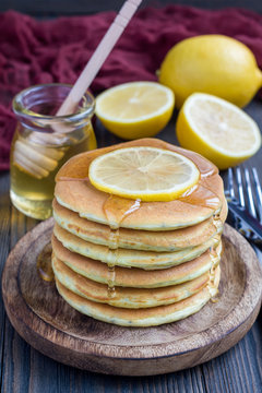 Healthy homemade lemon and chia seed pancakes served with honey, vertical