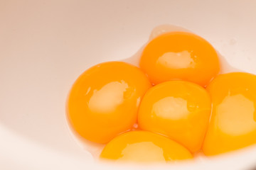 Hands holding egg shell with egg yolk separated