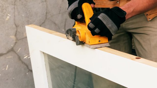 Carpenter polishing a wooden frame