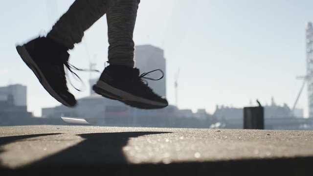 4K Sporty male skipping in the city on a sunny morning, in slow motion
