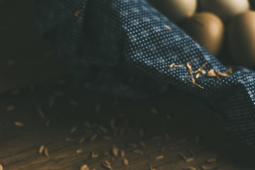 Group of Organic Eggs in VintageBlanket on Wooden Table