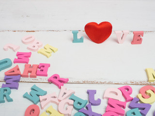 Vanlentine's day concept. Wooden letters word love and red heart  and car vintage on color background with copy space.