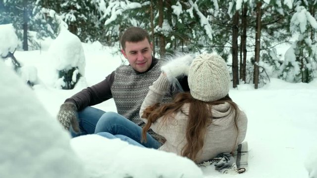 Guy and girl photographed in winter forest