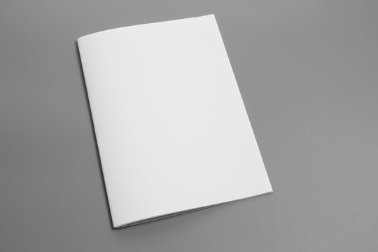 Blank portrait A4. brochure magazine isolated on gray, changeable background / white paper isolated on gray
