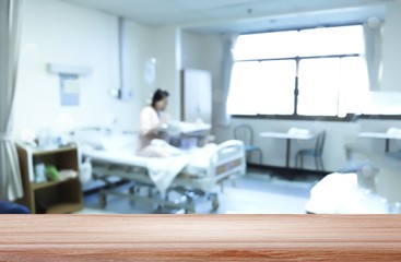 empty wooden top on Blurred of patient and healthcare after surgery in the recovery room background
