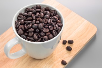 Coffee beans with mug on the wooden background, Coffee view from above