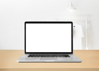 Fototapeta premium Laptop with blank screen on table against interior background