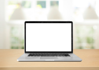 Fototapeta premium Laptop with blank screen on table. white room background